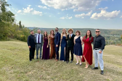 Wedding guest in a Burgundy crepe wrap maxi dress at an outdoor October wedding