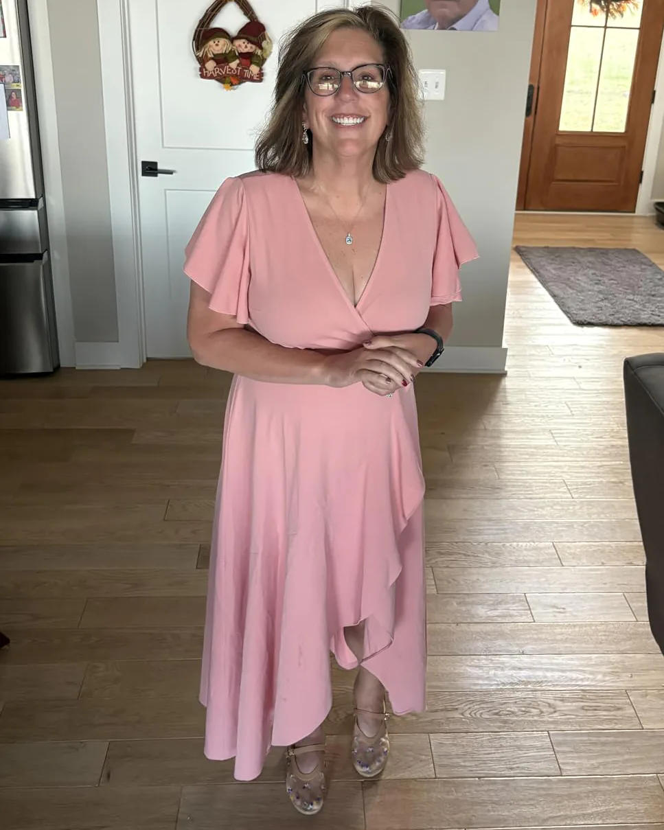 Woman in ZZV Atelier Blush Pink crepe wrap maxi dress for a spring wedding